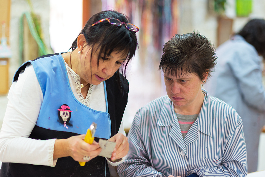 Occupational therapy NDIS support worker assisting a woman with disability